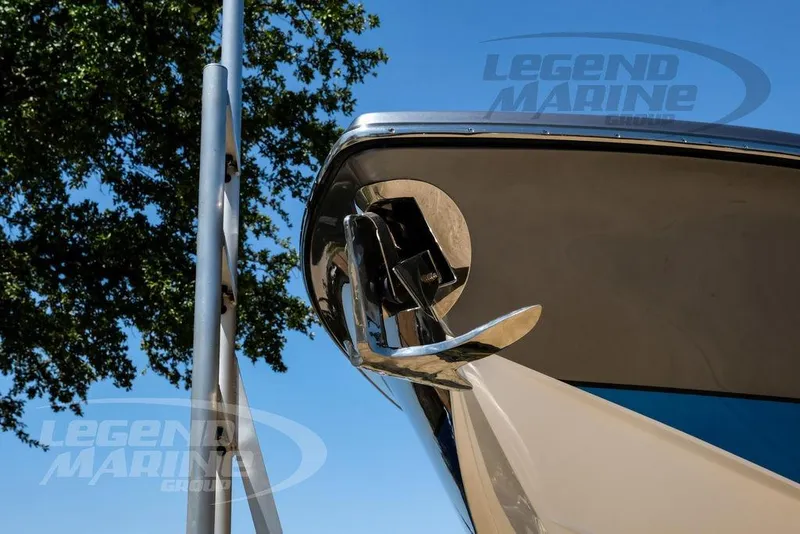 Slide: The Image of 2024 Nor-Tech 390 Sport Center Console boat bow with anchor, under clear blue sky. - 67