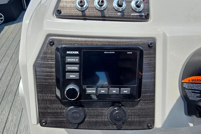 Slide: The Image of Control panel of 2023 Lowe SS 210 boat with media center and switches. - 12
