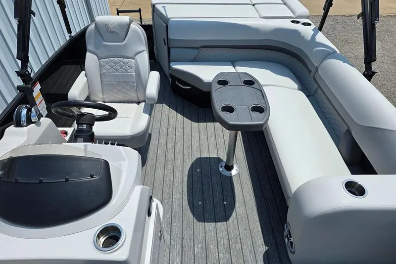 Slide: The Image of 2023 Lowe SS 210 boat interior with plush seating and steering console. - 5
