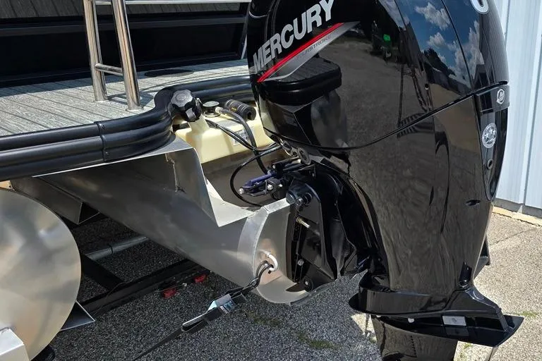 Slide: The Image of 2023 Lowe SS 210 boat with Mercury outboard motor, docked on a sunny day. - 8