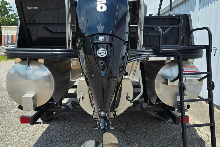 Slide: The Image of 2023 Lowe SS 210 pontoon boat with powerful outboard motor, parked outdoors. - 7