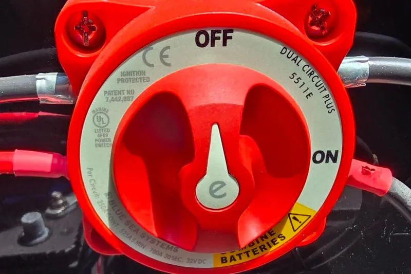 Slide: The Image of Red dual circuit battery switch on a 2023 Lowe SS 210 boat. - 14