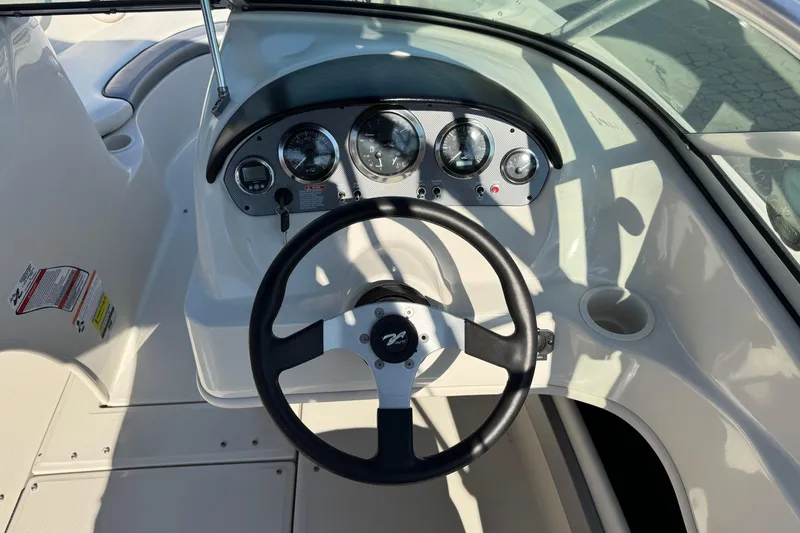 Slide: The Image of Steering console of a 2008 Sea Ray 205 Sport boat with gauges and controls. - 27