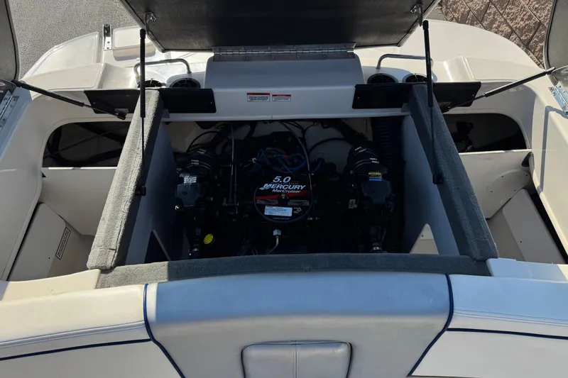 Slide: The Image of Open engine compartment of a 2008 Sea Ray 205 Sport boat, showcasing the 5.0 Mercury engine. - 20