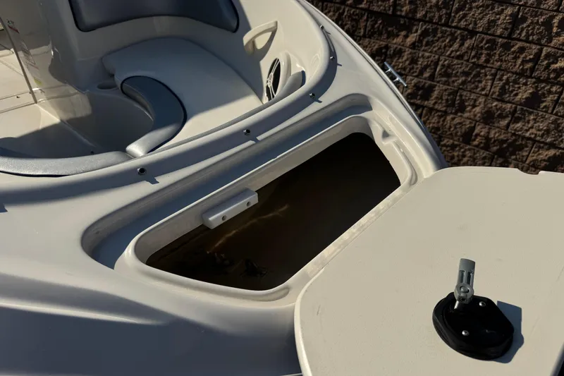 Slide: The Image of Open storage compartment on a 2008 Sea Ray 205 Sport boat, showcasing interior space. - 10