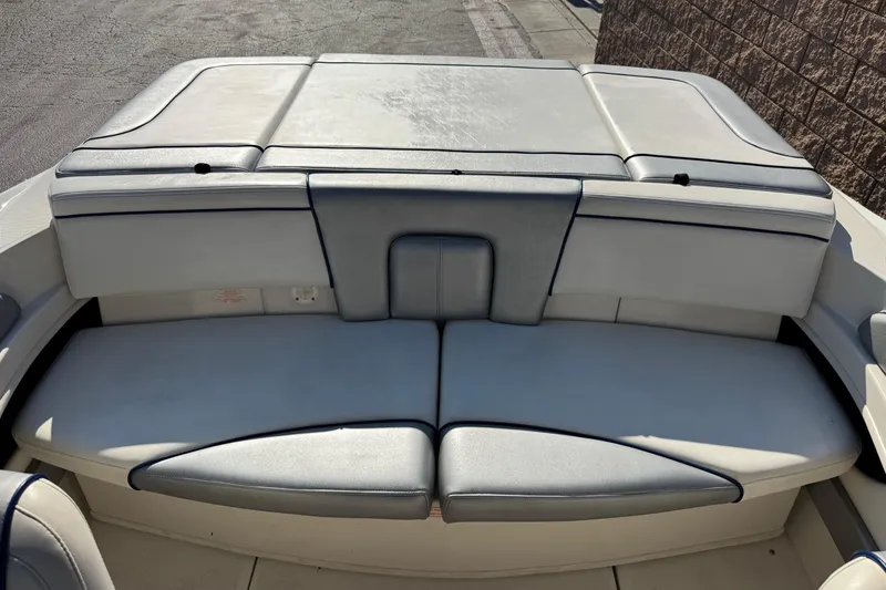 Slide: The Image of Rear seating area of a 2008 Sea Ray 205 Sport boat, featuring cushioned seats. - 18