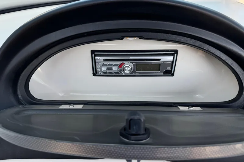 Slide: The Image of 2008 Sea Ray 205 Sport boat stereo system, featuring a Clarion audio unit. - 25