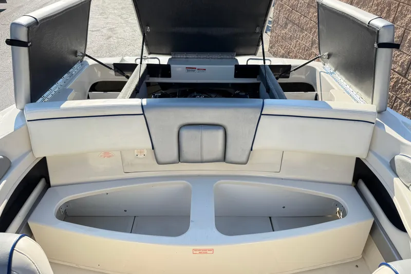 Slide: The Image of 2008 Sea Ray 205 Sport boat interior with open engine compartment and seating area. - 19
