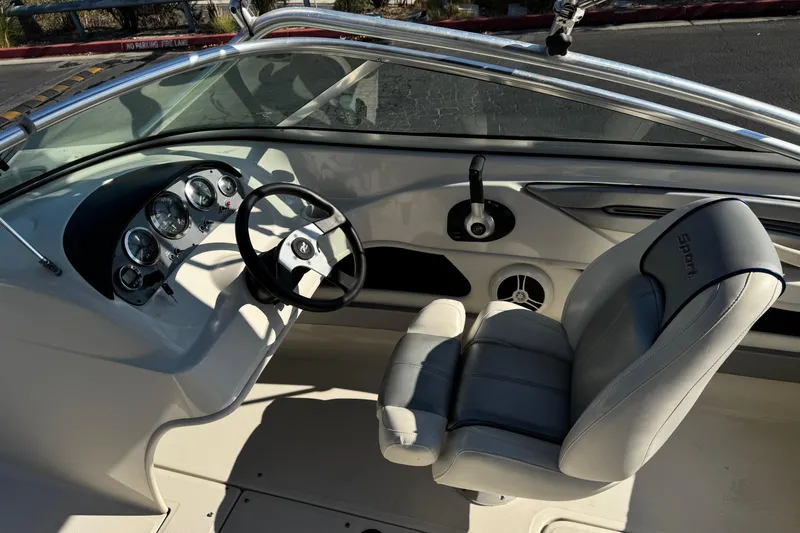Slide: The Image of Interior of a 2008 Sea Ray 205 Sport boat, featuring steering wheel and dashboard controls. - 26