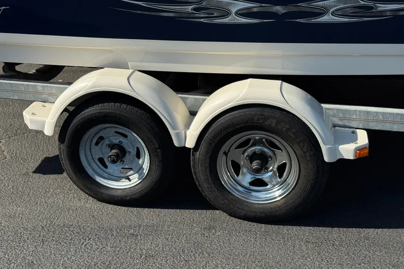 Slide: The Image of Trailer wheels of a 2008 Sea Ray 205 Sport boat on pavement. - 29
