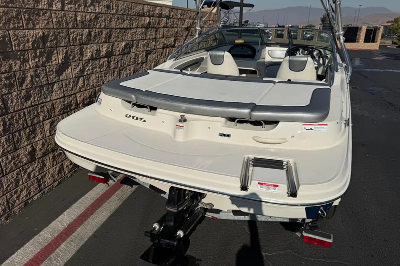 Slide: The Image of 2008 Sea Ray 205 Sport boat, rear view, parked on pavement near brick wall. - 6