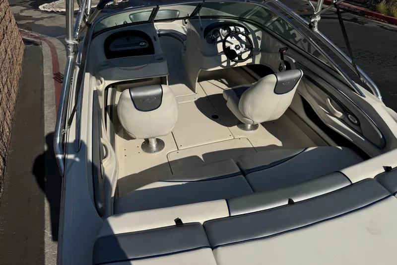 Slide: The Image of 2008 Sea Ray 205 Sport boat interior with white seating and steering wheel. - 8