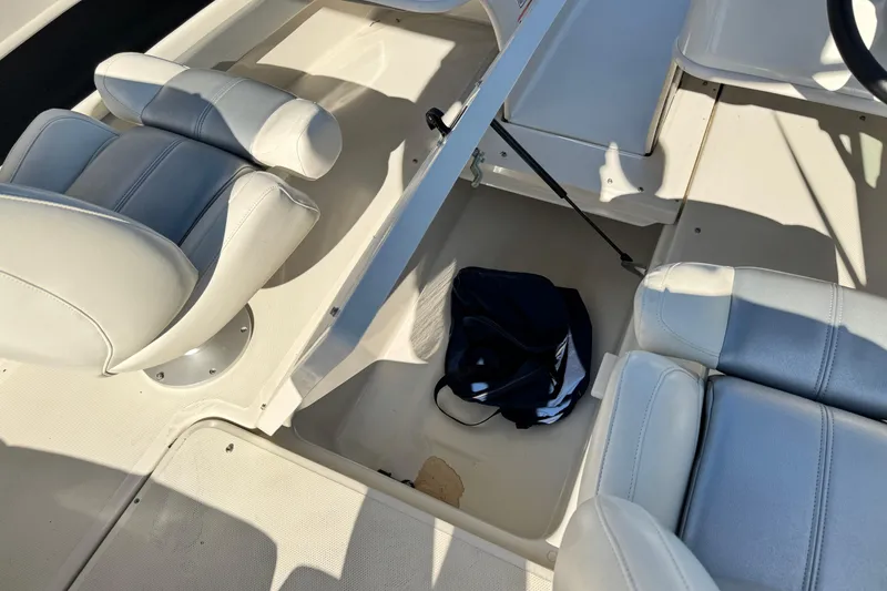 Slide: The Image of Interior of a 2008 Sea Ray 205 Sport boat with seating and storage area. - 22