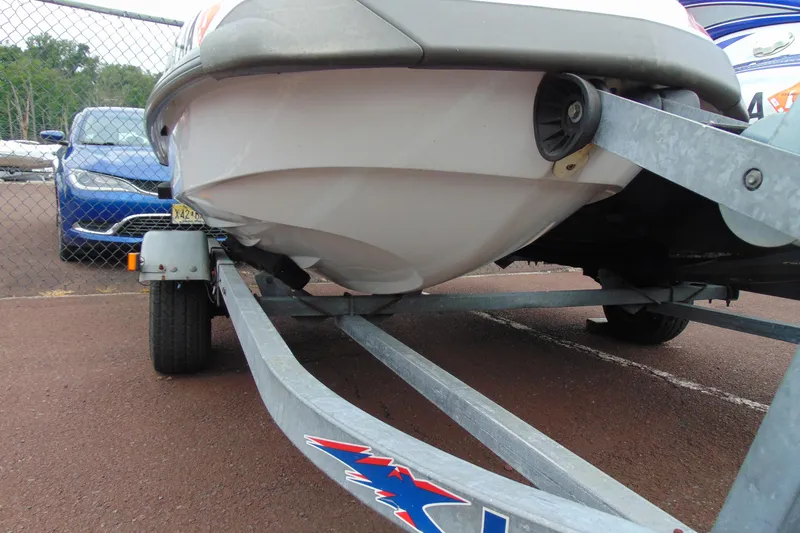 Slide: The Image of 2006 Yamaha WaveRunner FX on trailer, parked near a blue car, close-up view. - 6