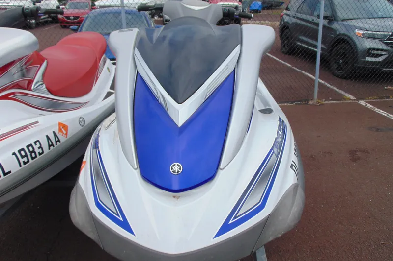 Slide: The Image of 2006 Yamaha WaveRunner FX jet ski with blue and white design in a parking lot. - 8