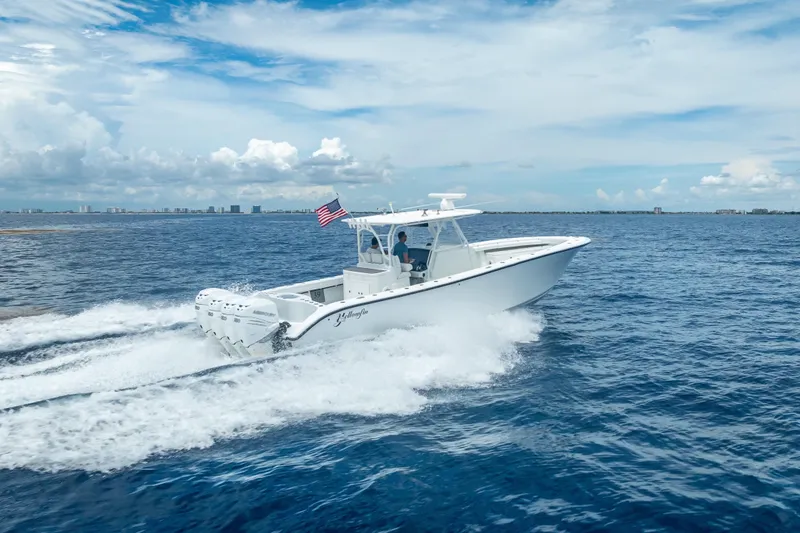 Slide: The Image of 2016 Yellowfin 39 Offshore boat cruising on open ocean under a clear sky. - 14