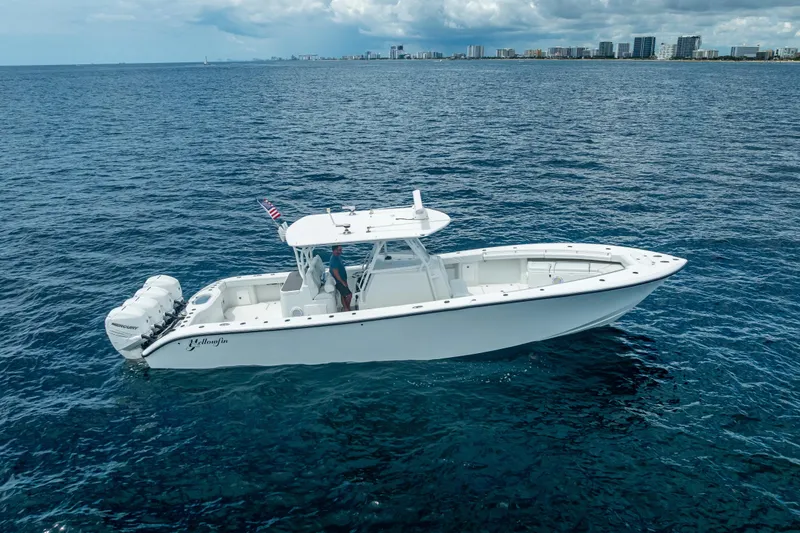 Slide: The Image of 2016 Yellowfin 39 Offshore boat cruising on open ocean under cloudy skies. - 6