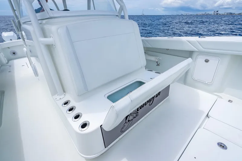Slide: The Image of 2016 Yellowfin 39 Offshore boat interior with open storage compartment, ocean view. - 45