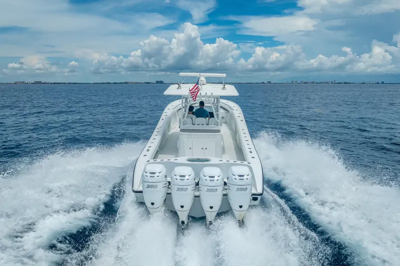 Slide: The Image of 2016 Yellowfin 39 Offshore boat cruising on open water with four engines. - 17