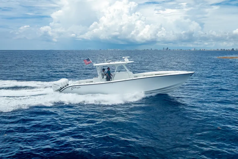 Slide: The Image of 2016 Yellowfin 39 Offshore boat cruising on open ocean under cloudy sky. - 13