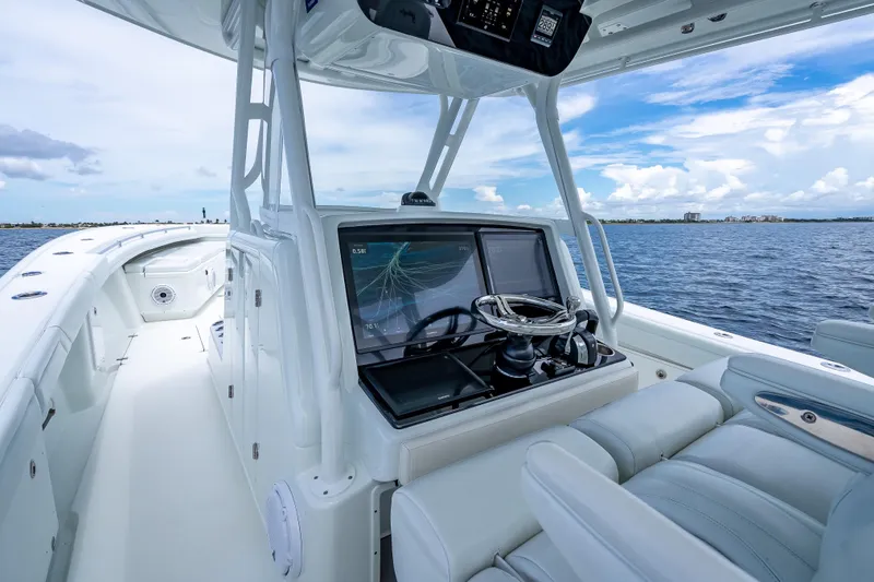 Slide: The Image of 2016 Yellowfin 39 Offshore boat interior with modern navigation system and ocean view. - 24
