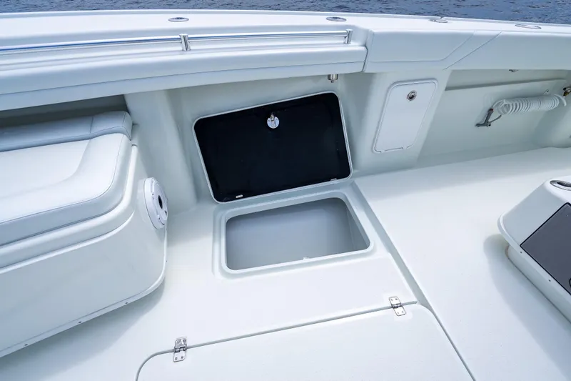 Slide: The Image of 2016 Yellowfin 39 Offshore boat interior with open storage compartment and seating. - 54