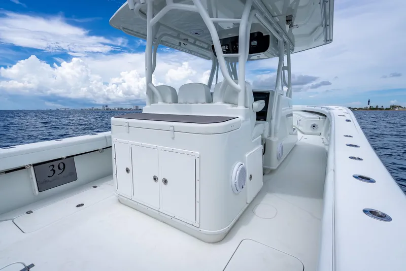 Slide: The Image of 2016 Yellowfin 39 Offshore boat on open water, showcasing sleek design and spacious deck. - 32