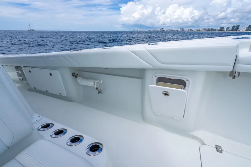 Slide: The Image of 2016 Yellowfin 39 Offshore boat interior with ocean view and storage compartments. - 52