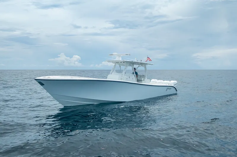 Slide: The Image of 2016 Yellowfin 39 Offshore boat cruising on open ocean under cloudy sky. - 1