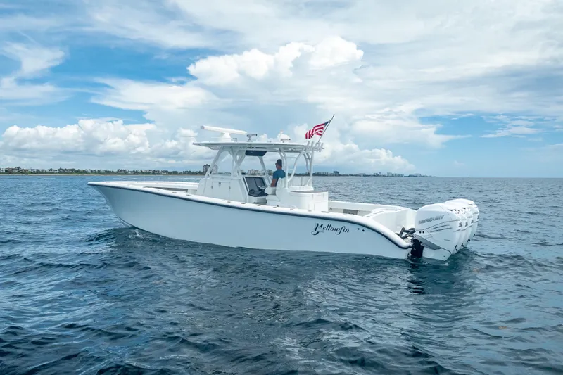 Slide: The Image of 2016 Yellowfin 39 Offshore boat on open water, featuring multiple outboard engines. - 2