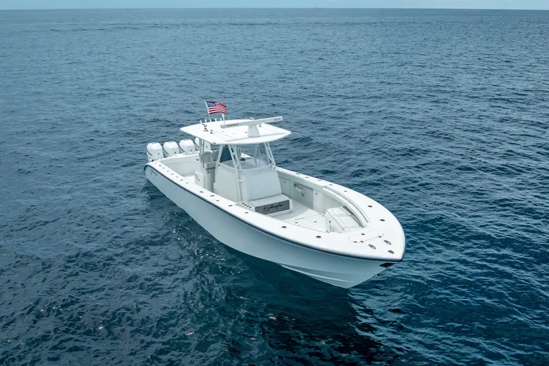 Slide: The Image of 2016 Yellowfin 39 Offshore boat on open ocean, featuring sleek design and American flag. - 5