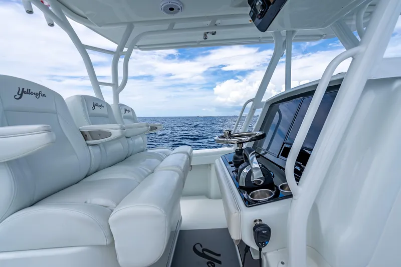 Slide: The Image of 2016 Yellowfin 39 Offshore boat interior with white seating and ocean view. - 27