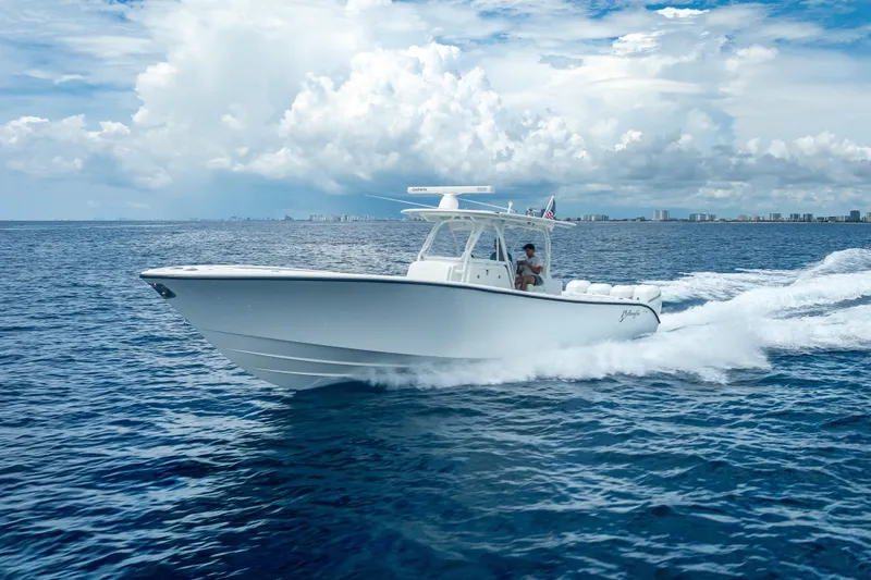 Slide: The Image of 2016 Yellowfin 39 Offshore boat cruising on open ocean under cloudy sky. - 10