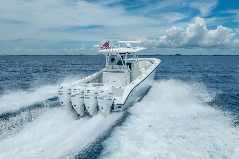 Slide: The Image of 2016 Yellowfin 39 Offshore boat cruising on open water with four engines. - 16
