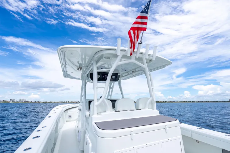 Slide: The Image of 2016 Yellowfin 39 Offshore boat with American flag on open water under blue sky. - 41