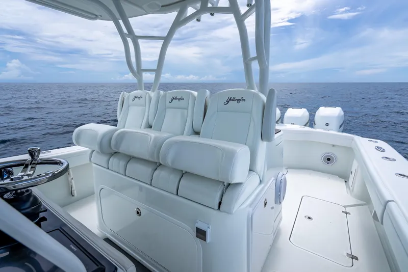 Slide: The Image of 2016 Yellowfin 39 Offshore boat interior with white seating and ocean view. - 30