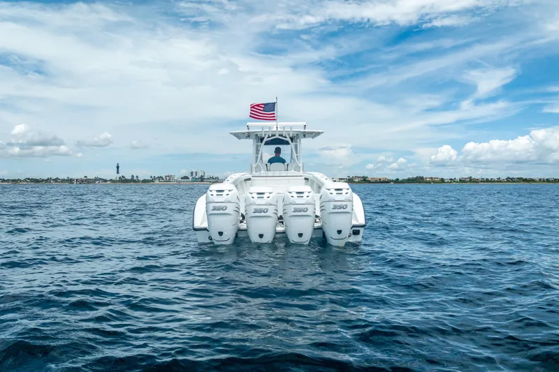 Slide: The Image of 2016 Yellowfin 39 Offshore boat with four engines on open water, American flag flying. - 21