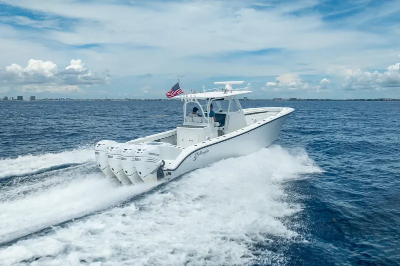 Slide: The Image of 2016 Yellowfin 39 Offshore boat cruising on open water with four engines. - 15