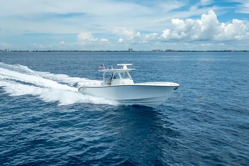 Slide: The Image of 2016 Yellowfin 39 Offshore boat cruising on open ocean under blue sky. - 12