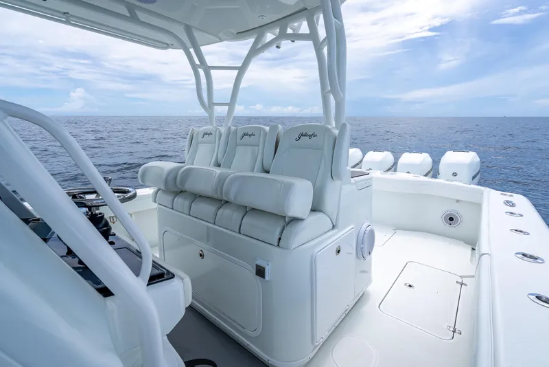 Slide: The Image of 2016 Yellowfin 39 Offshore boat interior with white seating, ocean view. - 29