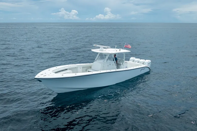 Slide: The Image of 2016 Yellowfin 39 Offshore boat cruising on open ocean under cloudy sky. - 3
