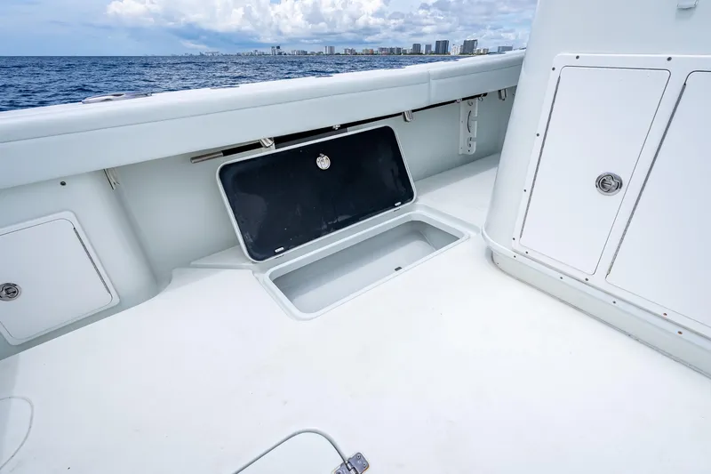Slide: The Image of 2016 Yellowfin 39 Offshore boat deck with open storage compartment, ocean view. - 58