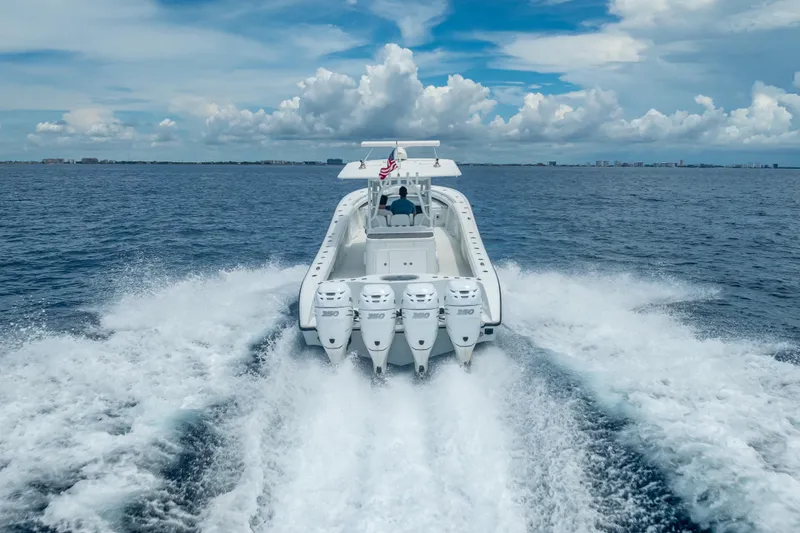 Slide: The Image of 2016 Yellowfin 39 Offshore boat cruising on open ocean with four powerful engines. - 18