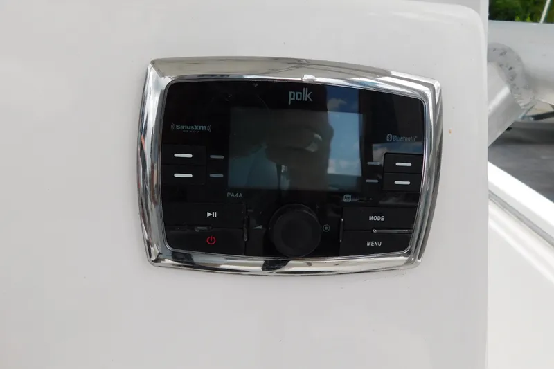 Slide: The Image of Polk audio system on 2017 Tidewater 198 CC Adventure boat dashboard. - 16