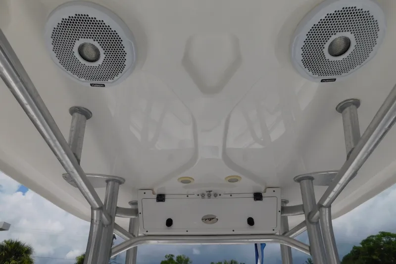 Slide: The Image of 2017 Tidewater 198 CC Adventure boat T-top with speakers and support poles. - 20