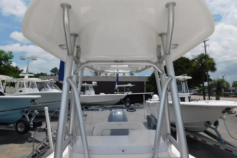 Slide: The Image of 2017 Tidewater 198 CC Adventure boat with T-top, displayed outdoors on a sunny day. - 8