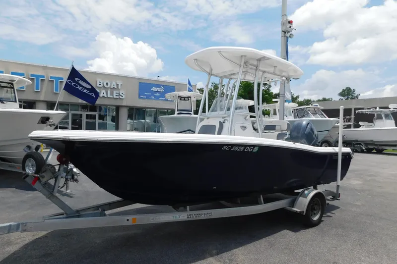 The Image of 2017 Tidewater 198 CC Adventure boat on trailer at dealership under blue sky. - 0