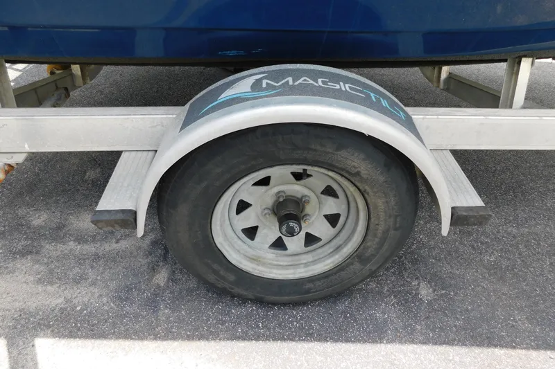 Slide: The Image of Trailer wheel of a 2017 Tidewater 198 CC Adventure boat on pavement. - 30