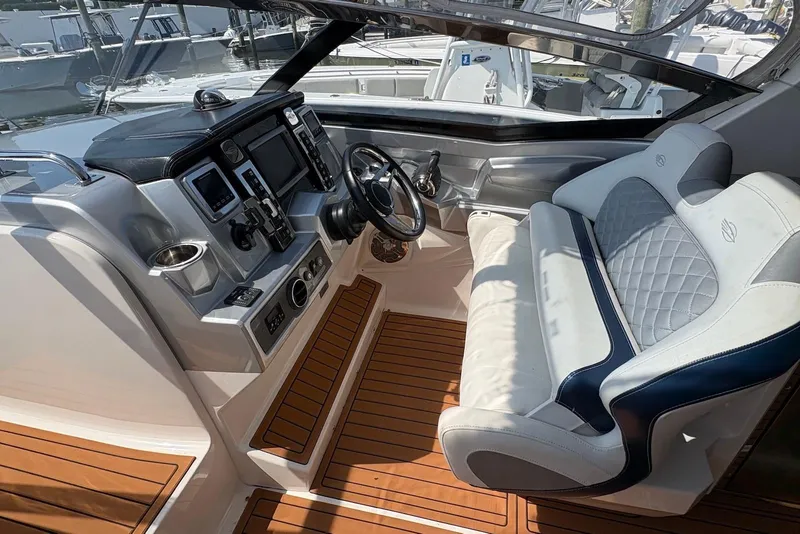 Slide: The Image of 2013 Chaparral 327 SSX boat cockpit with modern controls and luxurious seating. - 8