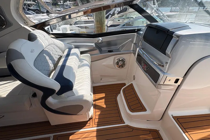 Slide: The Image of Interior of 2013 Chaparral 327 SSX boat with luxurious seating and wood flooring. - 9